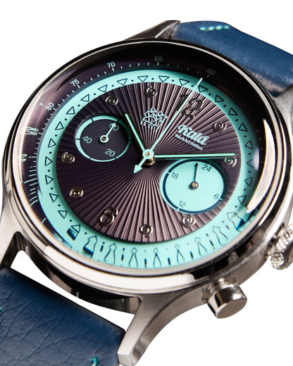 Watch with a blue strap and intricate face design on a white background