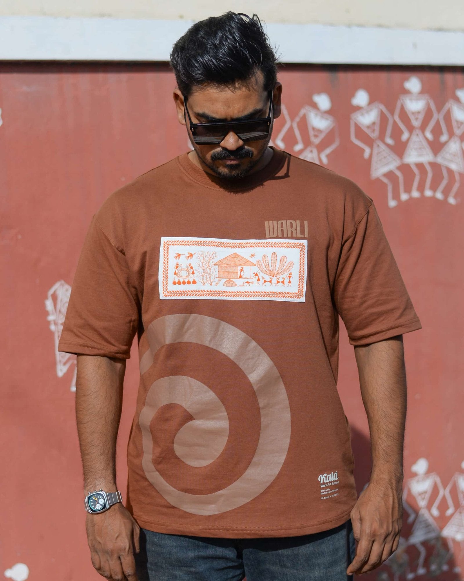 Hand painted Warli art t-shirt. Brown t-shirt with authentic tribal artwork by Warli artisans.