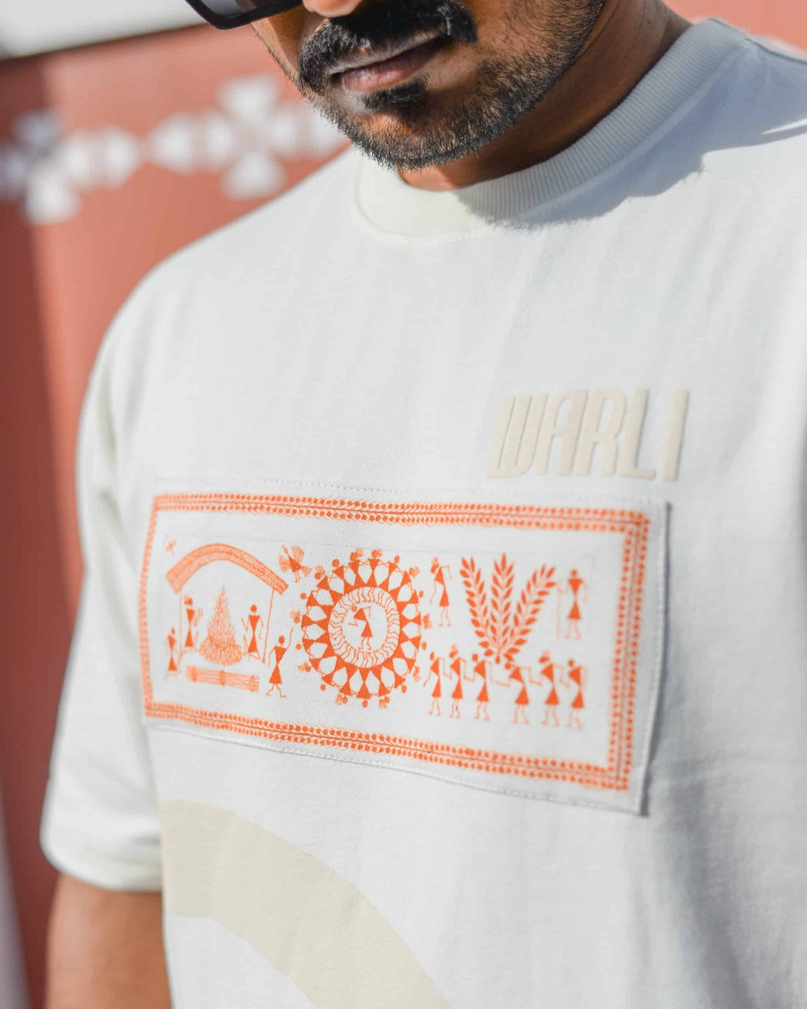 Hand painted Warli art t-shirt. Off-white t-shirt with authentic tribal artwork by Warli artisans.