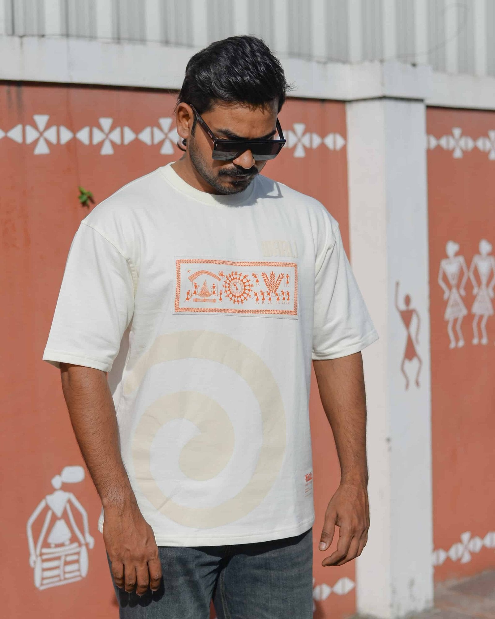 Hand painted Warli art t-shirt. Off-white t-shirt with authentic tribal artwork by Warli artisans.